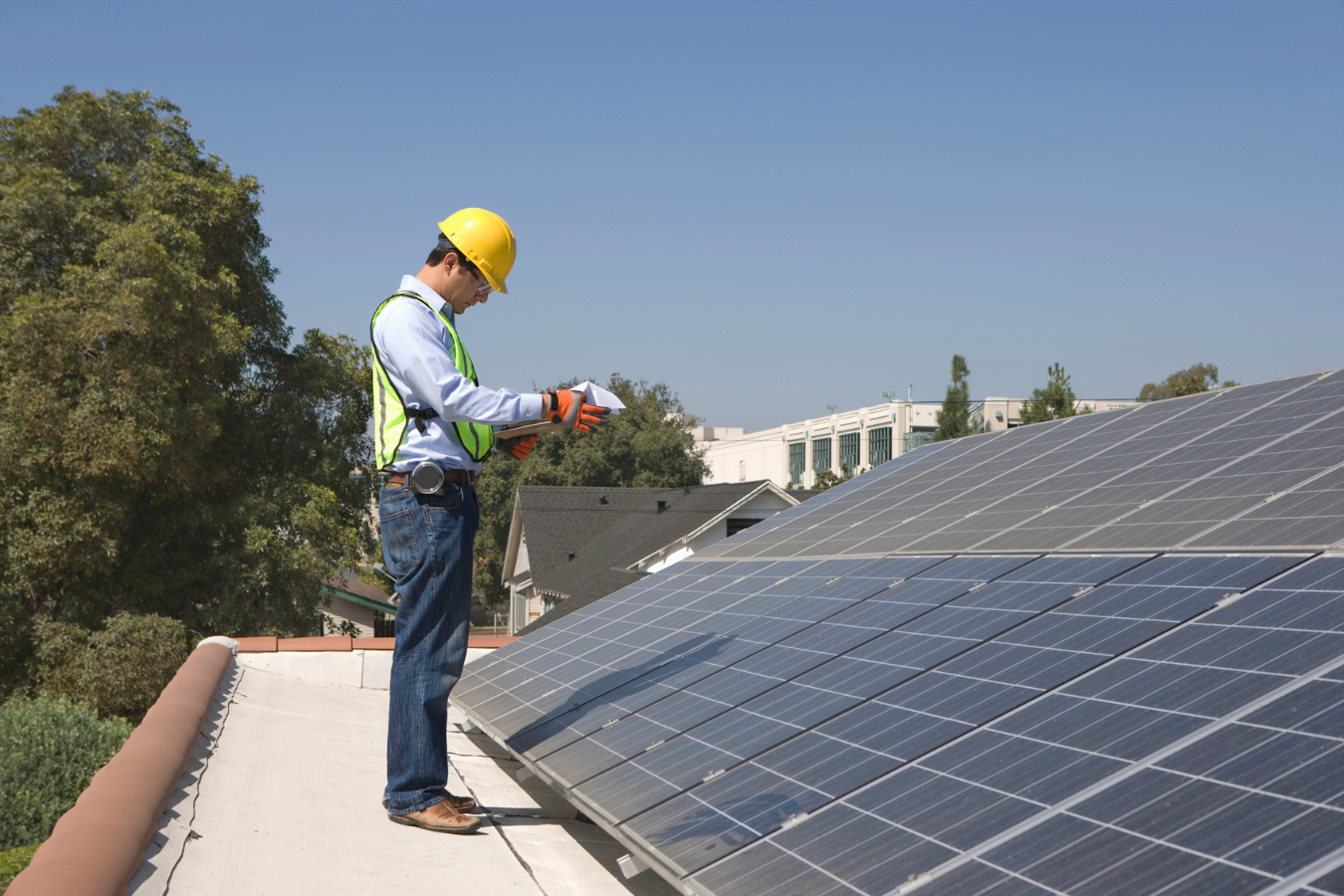 Man Inspecting Solar Panels